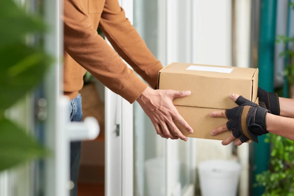 person receiving a cardboard box home delivery utc ()