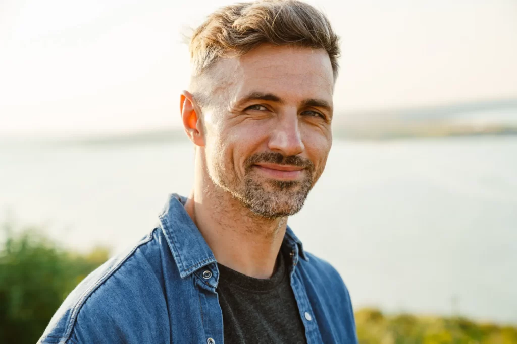 smiling man with blue denim shirt outdoors portrai utc